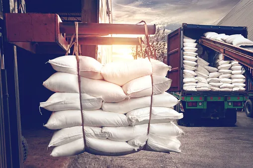 forklift handling white sugar bags stuffing into a container truck