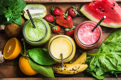 freshly blended fruit smoothies of various colors and tastes