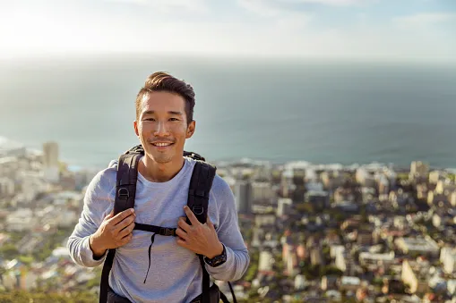 portrait of hiker smiling against sea