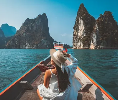 traveler asian woman relax and travel on thai longtail boat in ratchaprapha dam at khao sok